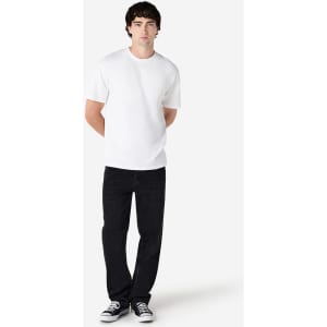 A model wearing a plain white Gildan Hammer adult t-shirt, paired with black jeans and sneakers, standing against a neutral background.