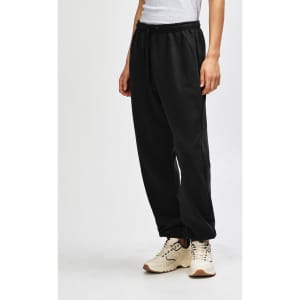 Unisex sweatpants in black with a drawstring waist, showcased on a model standing sideways.