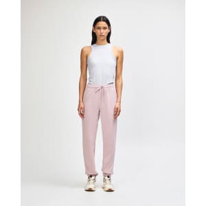 A pair of pink unisex sweatpants made from fleece, featuring a logo and side pockets.