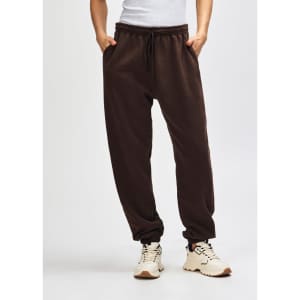 Brown unisex sweatpants with an elastic waistband and drawstring, featuring a relaxed fit and a logo.