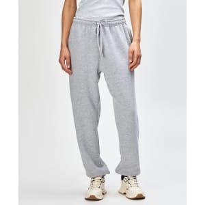 Grey unisex sweatpants with an elastic waistband and cuffs, featuring side pockets and a logo.