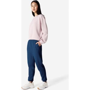 Unisex navy sweatpants paired with a light pink sweatshirt, featuring a logo on the pants.