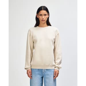 A unisex cream sweatshirt made from fleece with a crewneck design and ribbed cuffs. It has a branding logo.