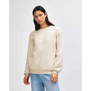 A unisex crewneck sweatshirt in a light beige colour, featuring a simple design and a logo on the chest.