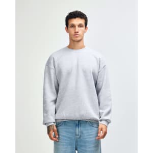 A unisex crewneck sweatshirt in light grey, featuring long sleeves and a comfortable fit. It has a branding logo.