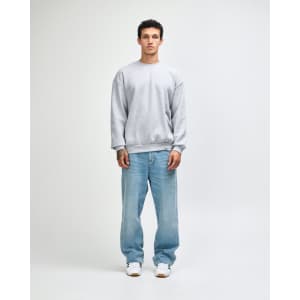 A grey unisex crewneck sweatshirt displayed on a model wearing black cargo pants and sneakers.