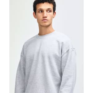 A unisex crewneck sweatshirt in grey, featuring long sleeves and a comfortable fit. It includes a logo.