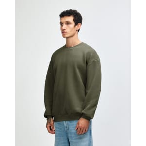 A unisex crewneck sweatshirt in green, featuring long sleeves and a relaxed fit, with a logo at the hem.