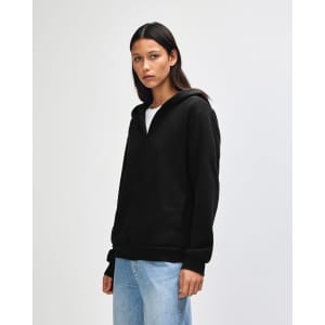 A black unisex full zip hooded sweatshirt displayed on a model, featuring a hood and front pockets.