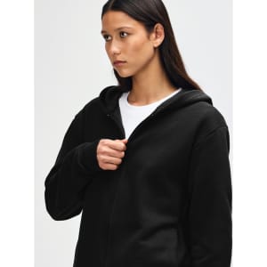 A black unisex full zip hooded sweatshirt features a hood and a front zip, displayed on a model.