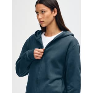 A navy unisex full zip hooded sweatshirt with a relaxed fit and a logo on the front.