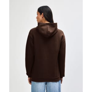 A unisex hooded sweatshirt in brown, featuring a spacious hood and a relaxed fit, with branding on the garment.