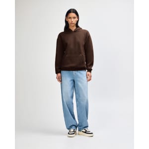 A unisex hooded sweatshirt in brown, featuring a front pocket and paired with black cargo pants.