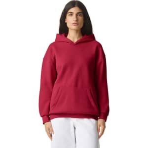A unisex hooded sweatshirt in a deep red colour with a front pocket and a relaxed fit. It features a logo.