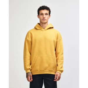 A unisex hooded sweatshirt in mustard yellow with a front pocket and a logo.