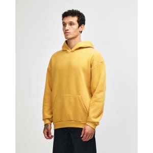 A unisex hooded sweatshirt in mustard yellow with a kangaroo pocket and a logo.