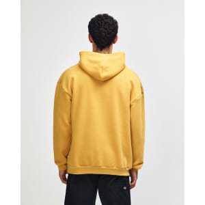 A unisex hooded sweatshirt in mustard yellow, featuring a spacious fit and a hood at the back. It has a branding logo.