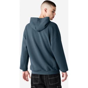 A unisex hooded sweatshirt in a blue hue, featuring a relaxed fit and a hood. It has a logo on the back.