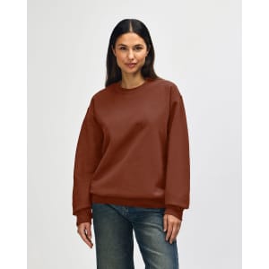 A brown Gildan Softstyle adult sweatshirt displayed on a model, featuring a classic crew neck and long sleeves.