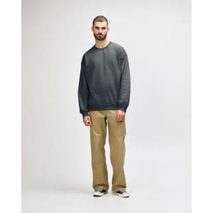 A green Gildan Softstyle adult sweatshirt displayed on a model, paired with black pants and sneakers.