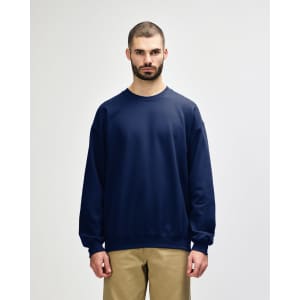 A navy Gildan Softstyle adult sweatshirt with a crew neckline and long sleeves. Features a logo on the chest.