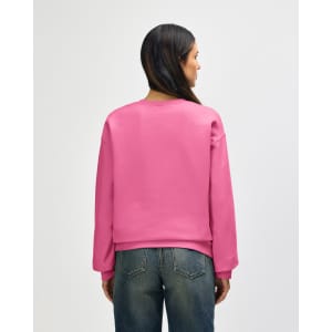 A pink Gildan Softstyle adult sweatshirt seen from the back, paired with blue jeans. The sweatshirt has a logo.