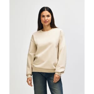 A cream-coloured Gildan Softstyle adult sweatshirt displayed on a model, featuring long sleeves and a crew neckline.