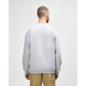 A grey Gildan Softstyle adult sweatshirt viewed from the back, worn with dark jeans. It features a logo.