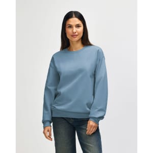A light blue Gildan Softstyle adult sweatshirt worn by a woman, featuring a classic crew neck and long sleeves.