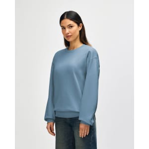 A soft blue sweatshirt with a crew neckline and long sleeves, featuring a logo on the chest.