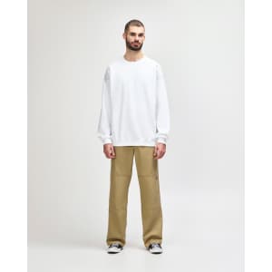 A white Gildan Softstyle adult sweatshirt displayed on a model, paired with black jeans and sneakers.