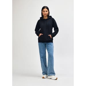 A black Gildan Softstyle adult hooded sweatshirt worn by a model with dark jeans and sneakers, featuring a logo.