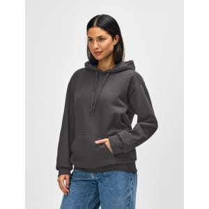 A hooded sweatshirt in olive green, featuring a front pocket and a drawstring hood. The model is wearing blue jeans.