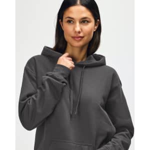 A hooded sweatshirt in earthy green, featuring a drawstring hood and a plain design. It includes a logo.