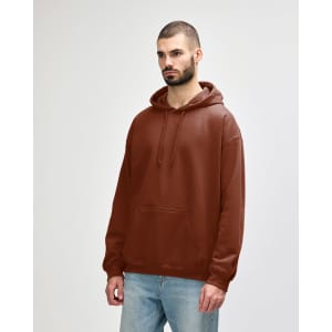 A brown hooded sweatshirt with a front pocket and drawstrings, worn by a model in casual attire.