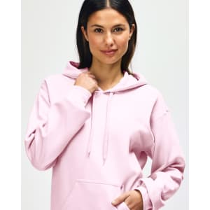 A pink hooded sweatshirt featuring a front pocket and a hood. The product has a logo on it.