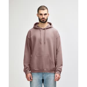 A hooded sweatshirt in a mauve colour, featuring a front pocket and drawstrings, worn by a model.