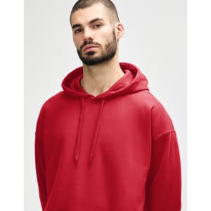 A red hooded sweatshirt is worn by a woman, featuring a drawstring hood and a relaxed fit.