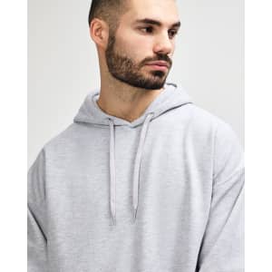 A grey Gildan Softstyle adult hooded sweatshirt featuring a drawstring hood and a simple design without visible branding.