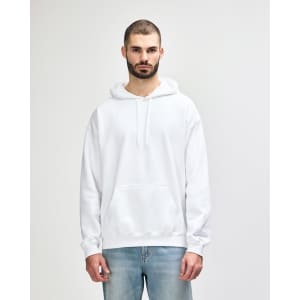 A white Gildan Softstyle adult hooded sweatshirt is worn by a model posing with one hand on her hip.