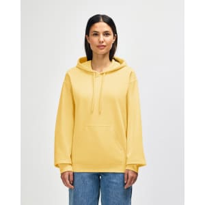 A yellow Gildan Softstyle adult hooded sweatshirt displayed on a model, featuring a front pocket and a logo.