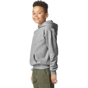 A youth grey hooded sweatshirt featuring a kangaroo pocket and a logo on the front, modelled by a smiling child.