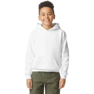 A youth hooded sweatshirt in white, featuring a front pocket and a logo. The model is smiling, wearing olive green pants.