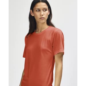 A red American Apparel Tri-Blend T-Shirt displayed on a model with long hair, featuring a simple design and short sleeves.