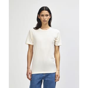 A cream-coloured American Apparel Tri-Blend T-shirt displayed on a model, featuring a simple design and fitted style.