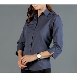 A dark navy button-up shirt with long sleeves, featuring a fitted design. The model is wearing a watch.