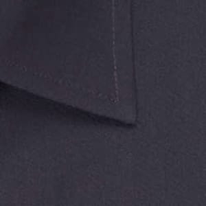 A close-up of a navy blue button-up shirt collar with stitching details and a logo.