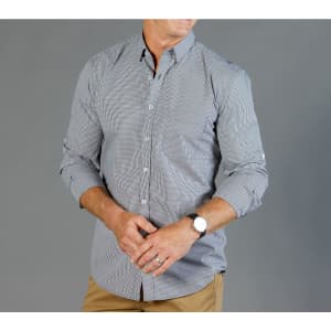 Button-up shirt in a black and white gingham pattern. Features long sleeves and a standard collar. Includes a logo.