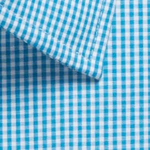 A close-up of a blue and white gingham patterned button-up shirt, featuring a collar and neat stitching.