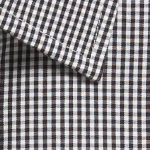 A close-up of a button-up shirt featuring a black and white gingham pattern, with a folded collar.